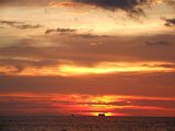 00395-1313 Tug and ship on the horizon of a setting sun at Miri - Sarawak - Photo by Garry K Smit